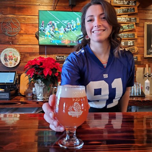 Jess M  and Conor are  serving up red beers , football and smiles today! 🍺🏈 #tra
