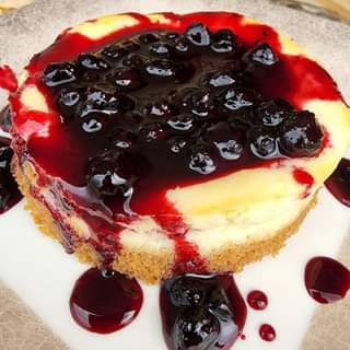 Housemade Lemon Cheesecake with huckleberry compote on a graham cracker crust, r